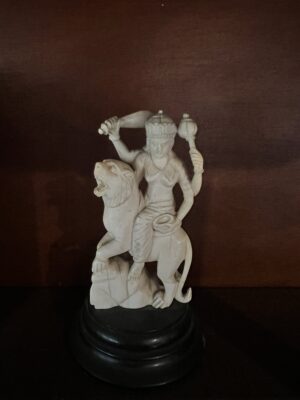 Carved white figurine on stand