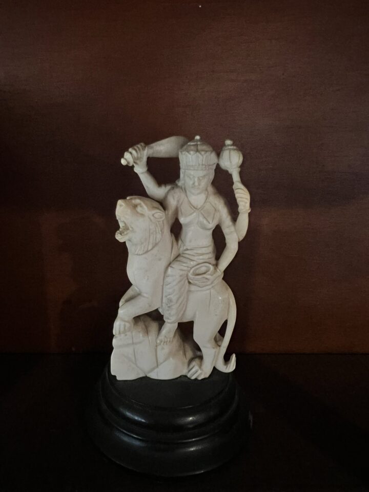Carved white figurine on stand