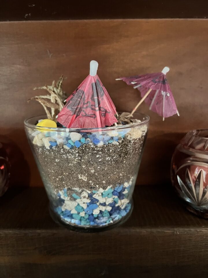 Sand art glass with paper umbrellas